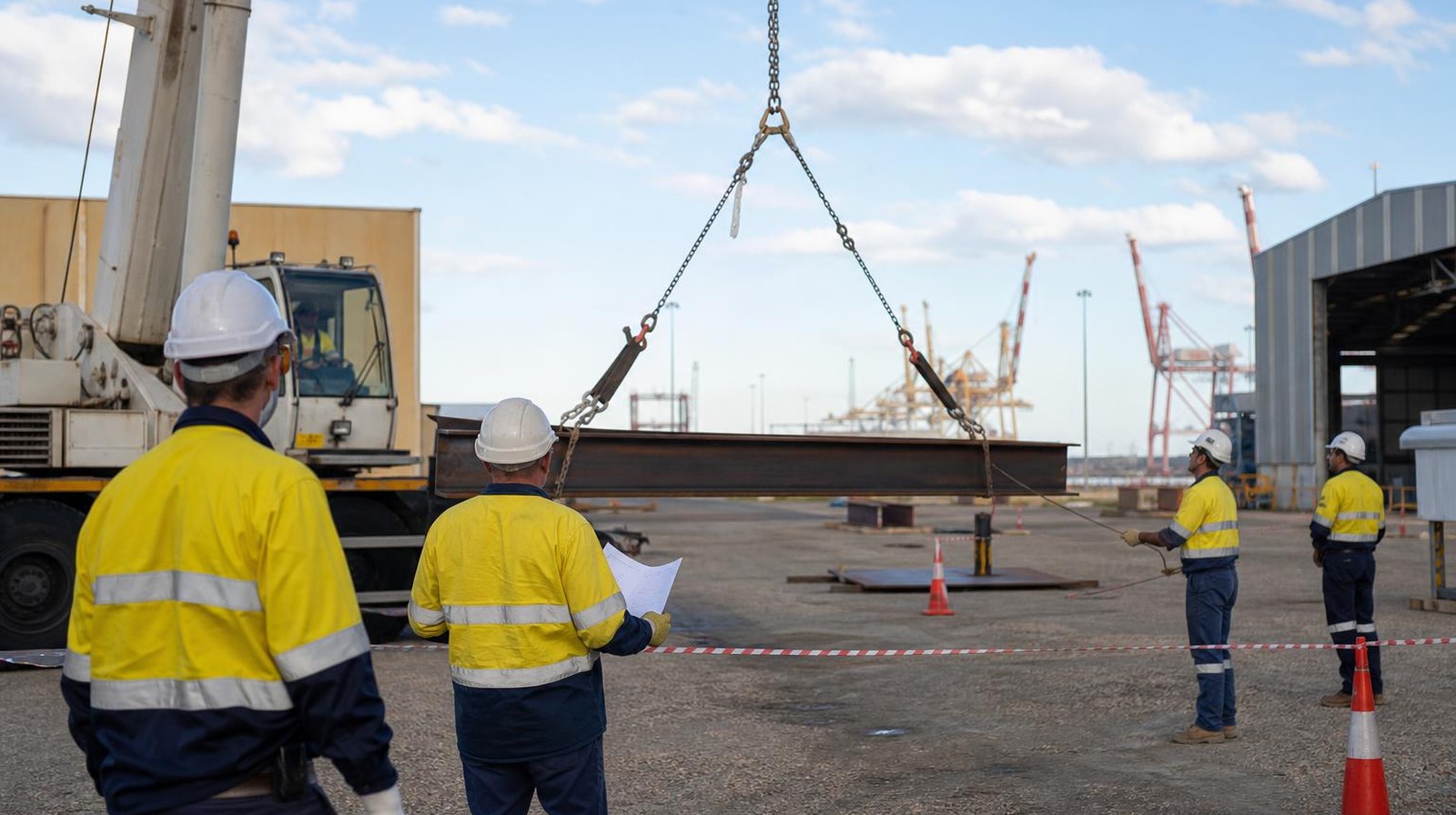 The Rigging Course Perth — Crane Lift Planning (Naval Base) Intermediate rigging trainees planning a crane lift of a steel beam during rigging course Perth training at Naval Base
